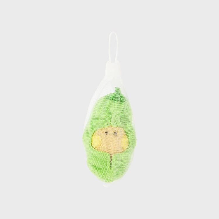 A green, avocado-shaped baby toy in a mesh bag.