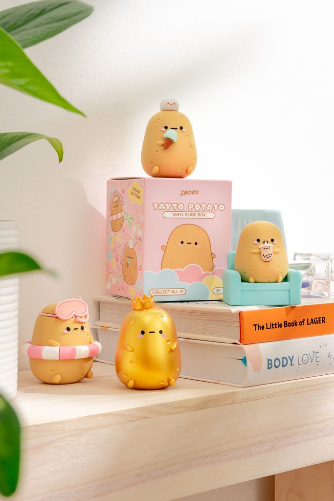 Toy potato figures and box on books.