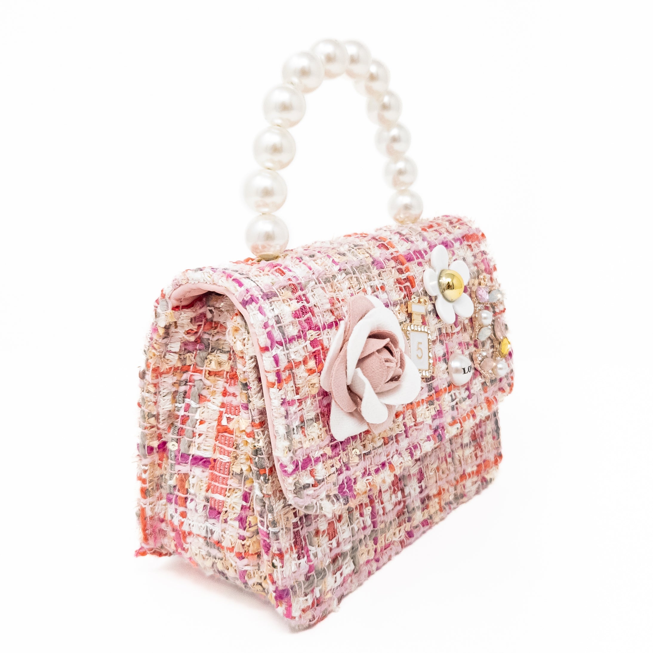 Pink tweed handbag with pearl handle and floral embellishments.