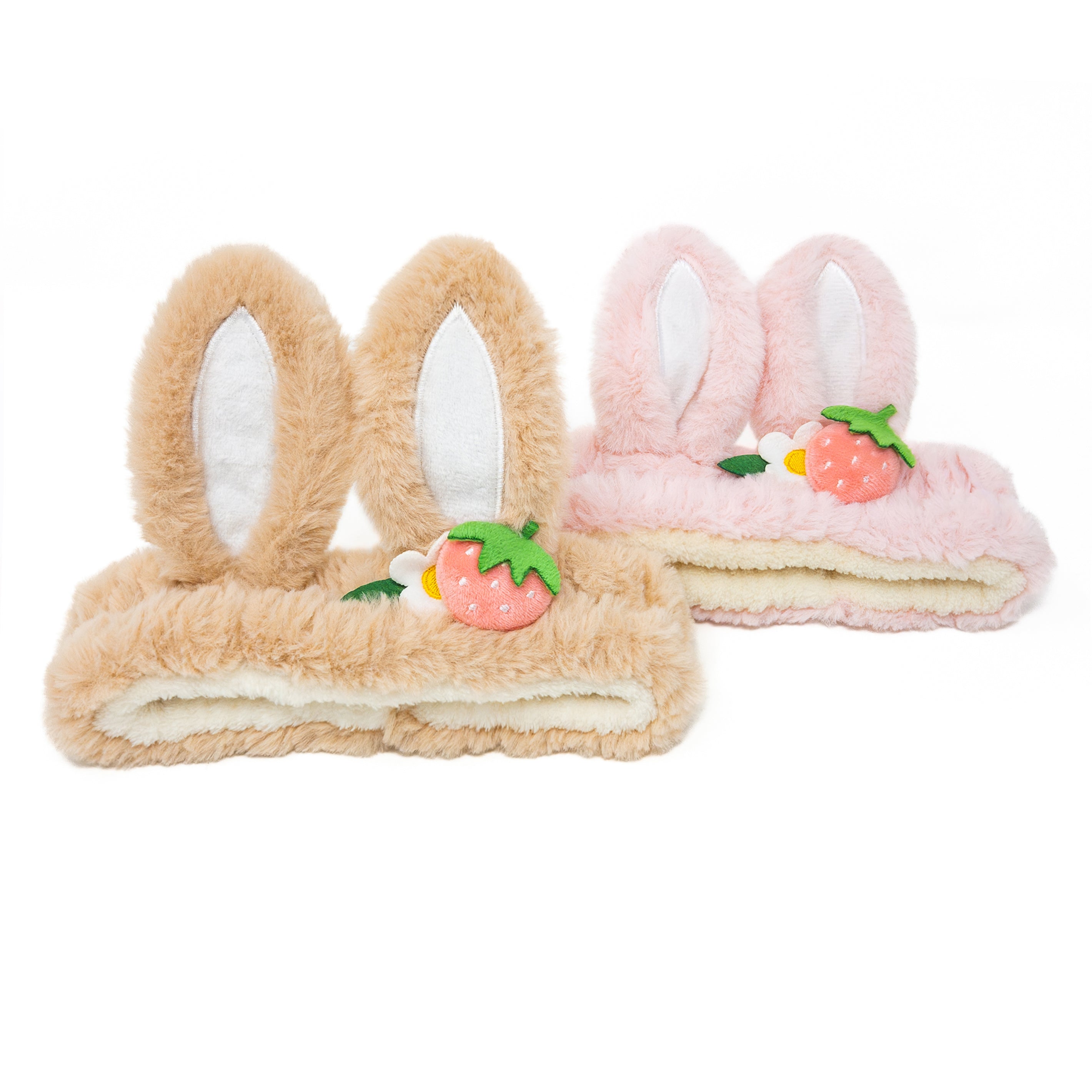 Two plush headbands, one brown and one pink, with bunny ears and strawberry accents.