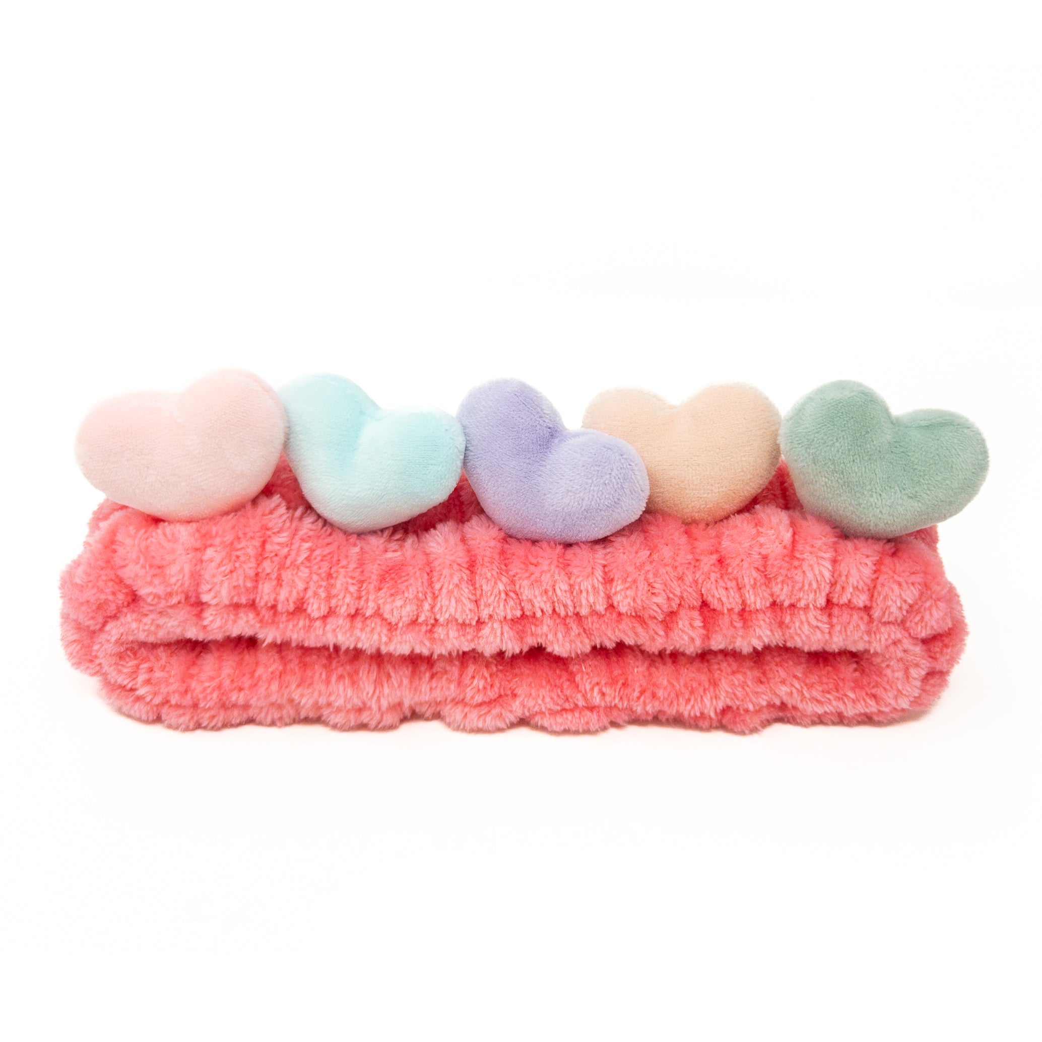 Pink plush headband with soft pastel hearts.