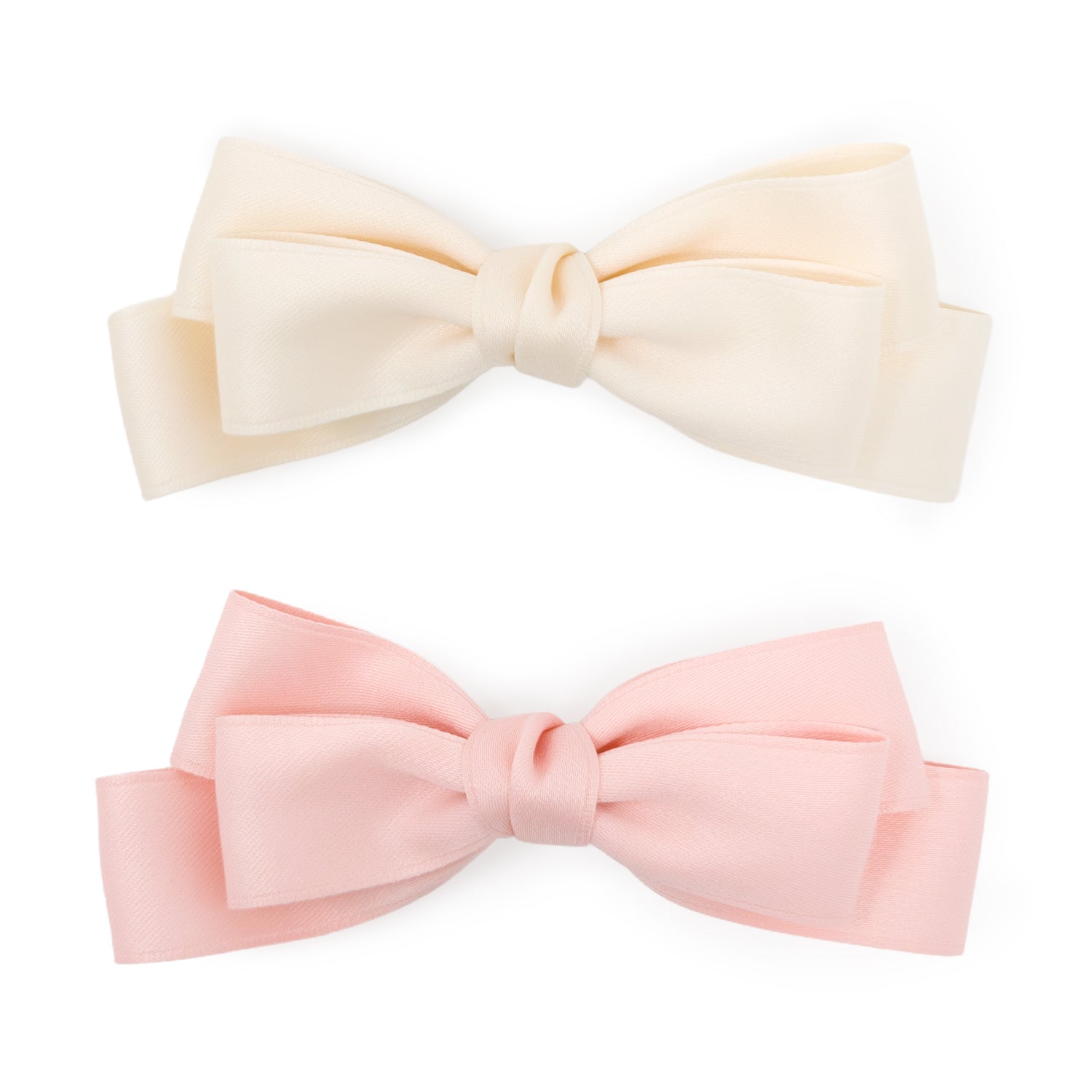 A set of two large double bow clips, one ivory and one pale pink satin ribbon, displayed side-by-side.