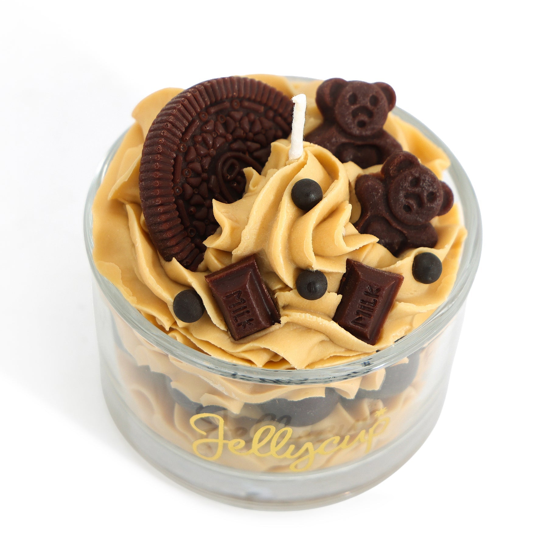Candle in a glass jar with cookie decorations on a white background
