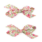 Two floral-patterned hair bows.