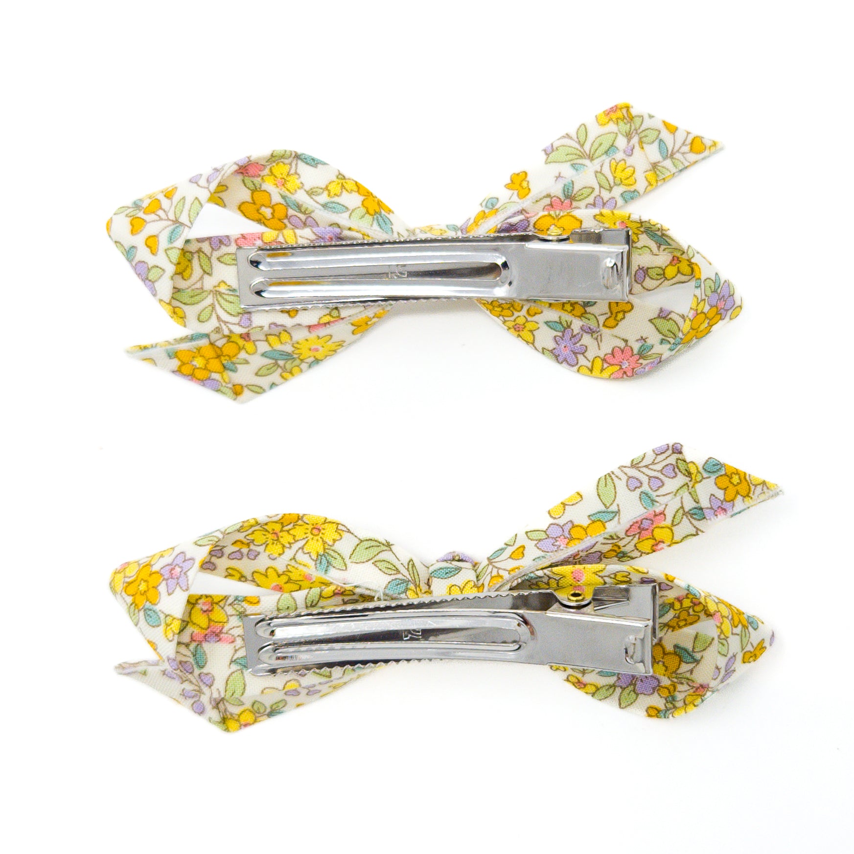 Two floral print hair clips on a white background.