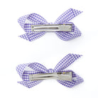 Two purple and white gingham hair clips.