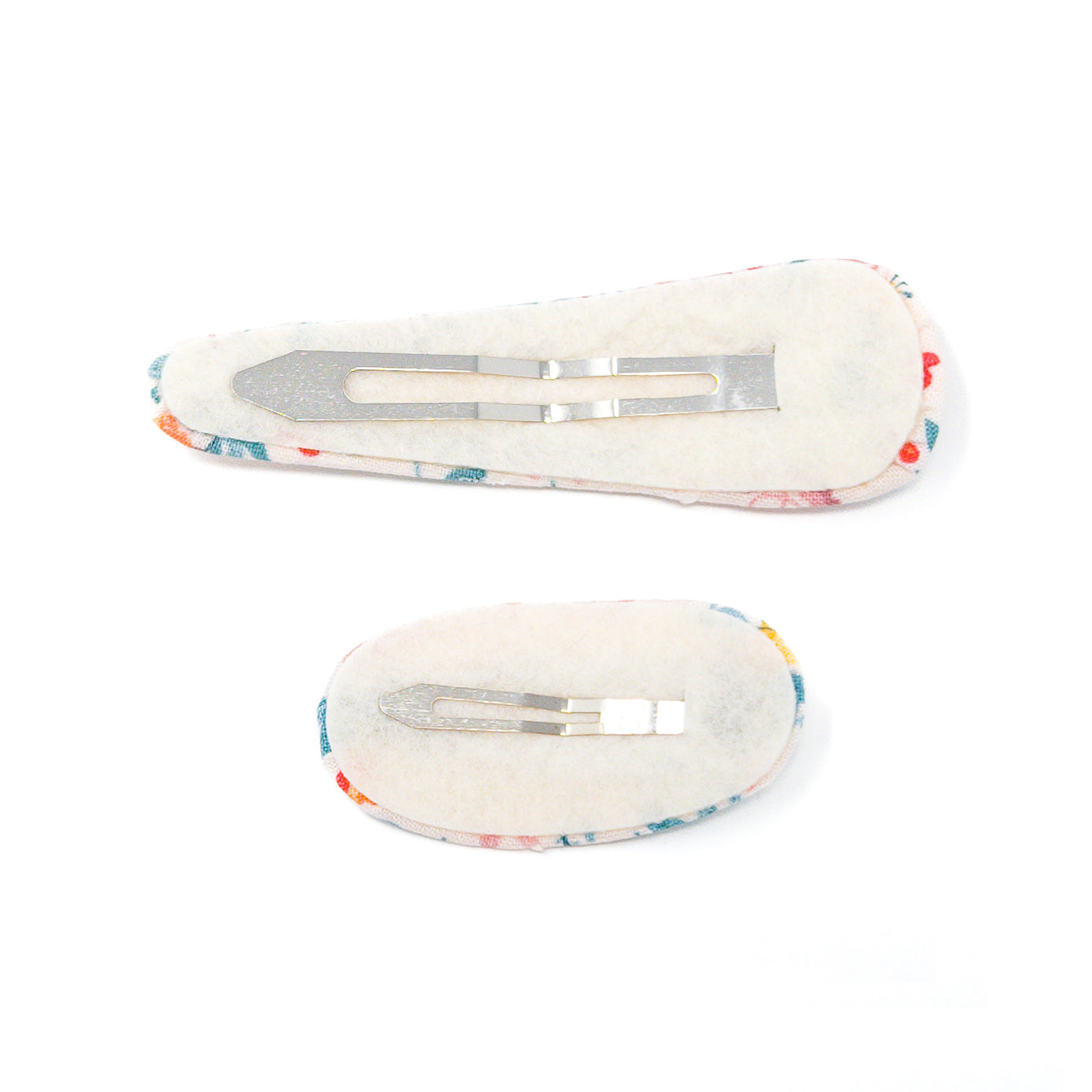 Two floral fabric hair clips with metal clips on the back.