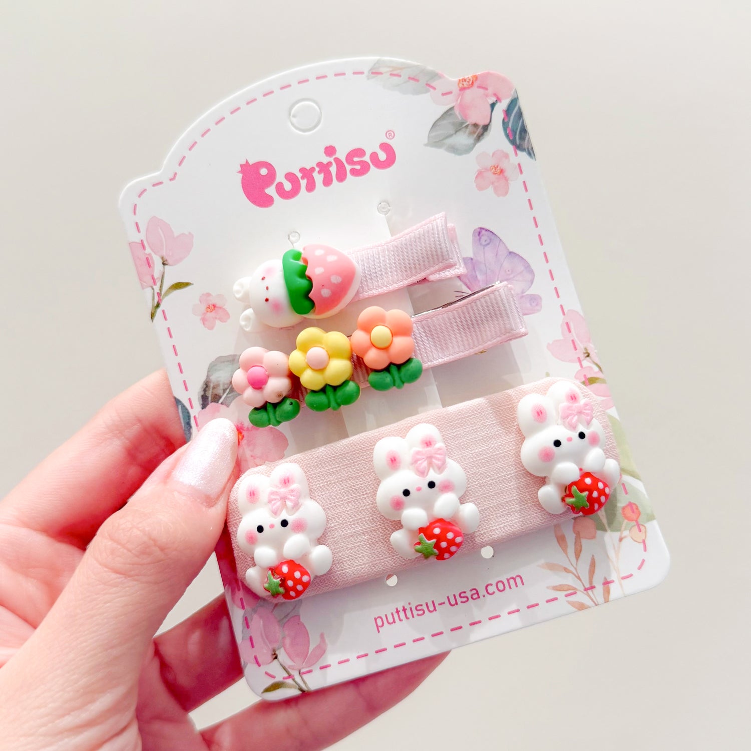 Three sets of hair clips with flowers, bunnies, and strawberries.