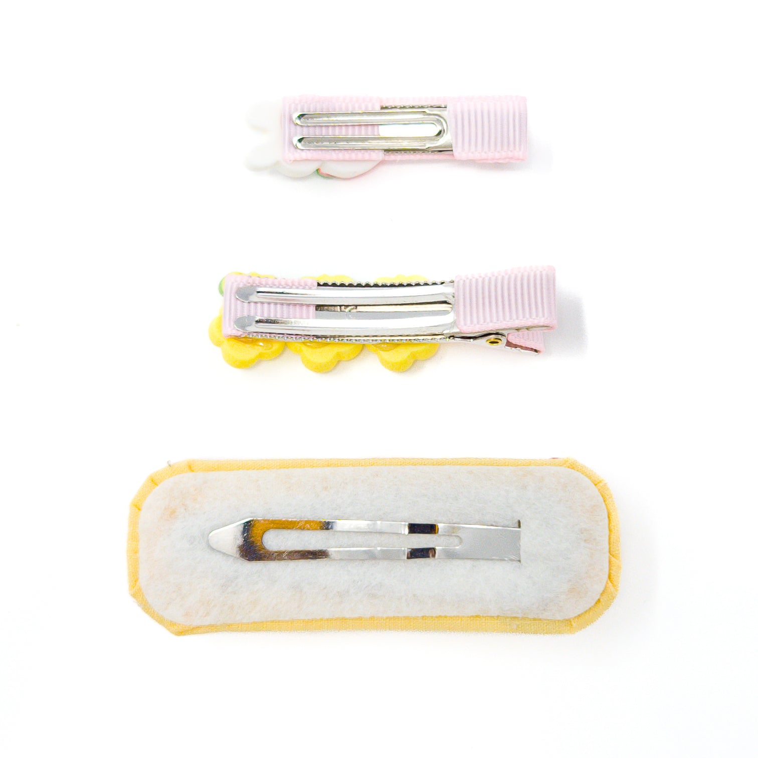 Three hair clips with alligator clips.