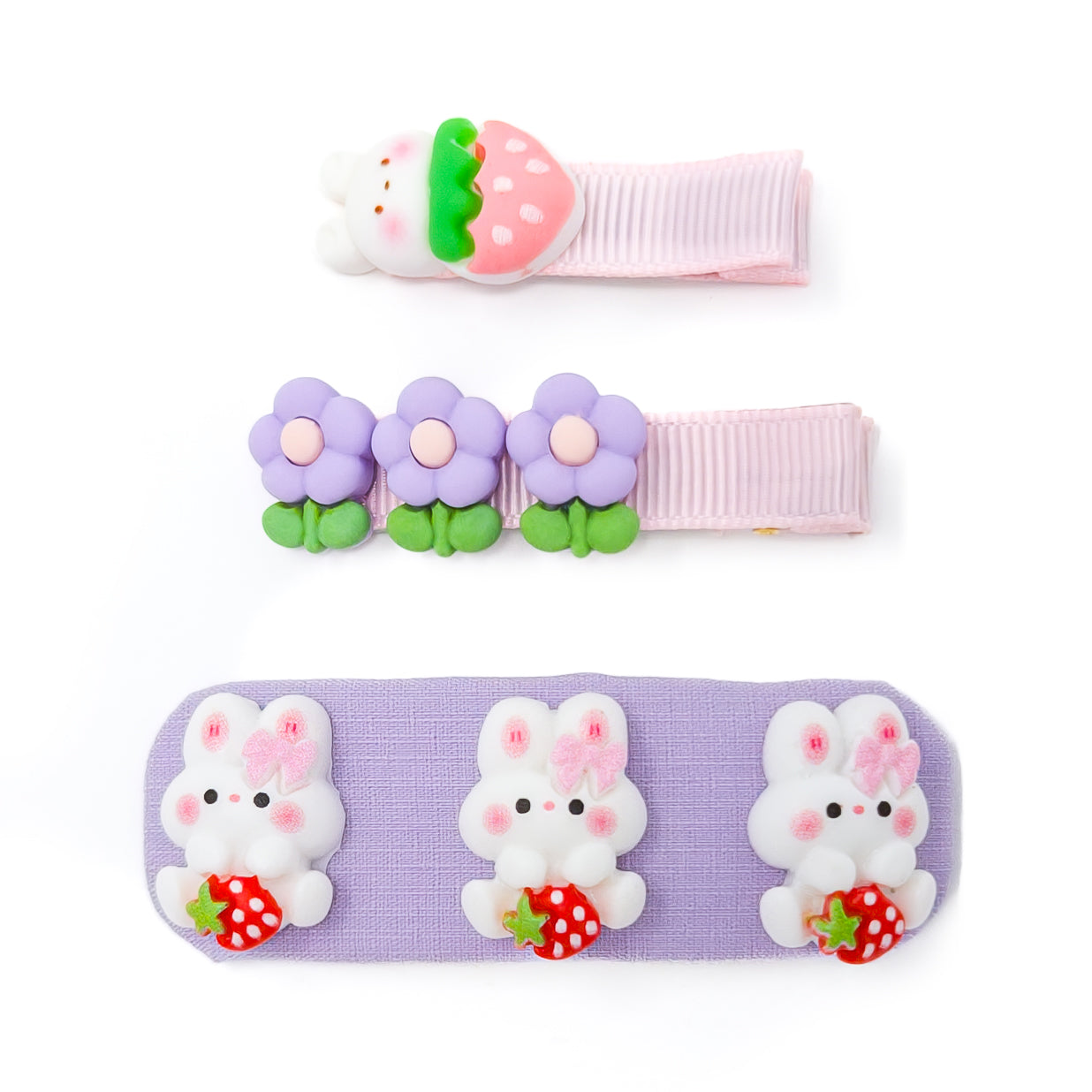 Three hair clips with cute cartoon decorations, on a white surface.