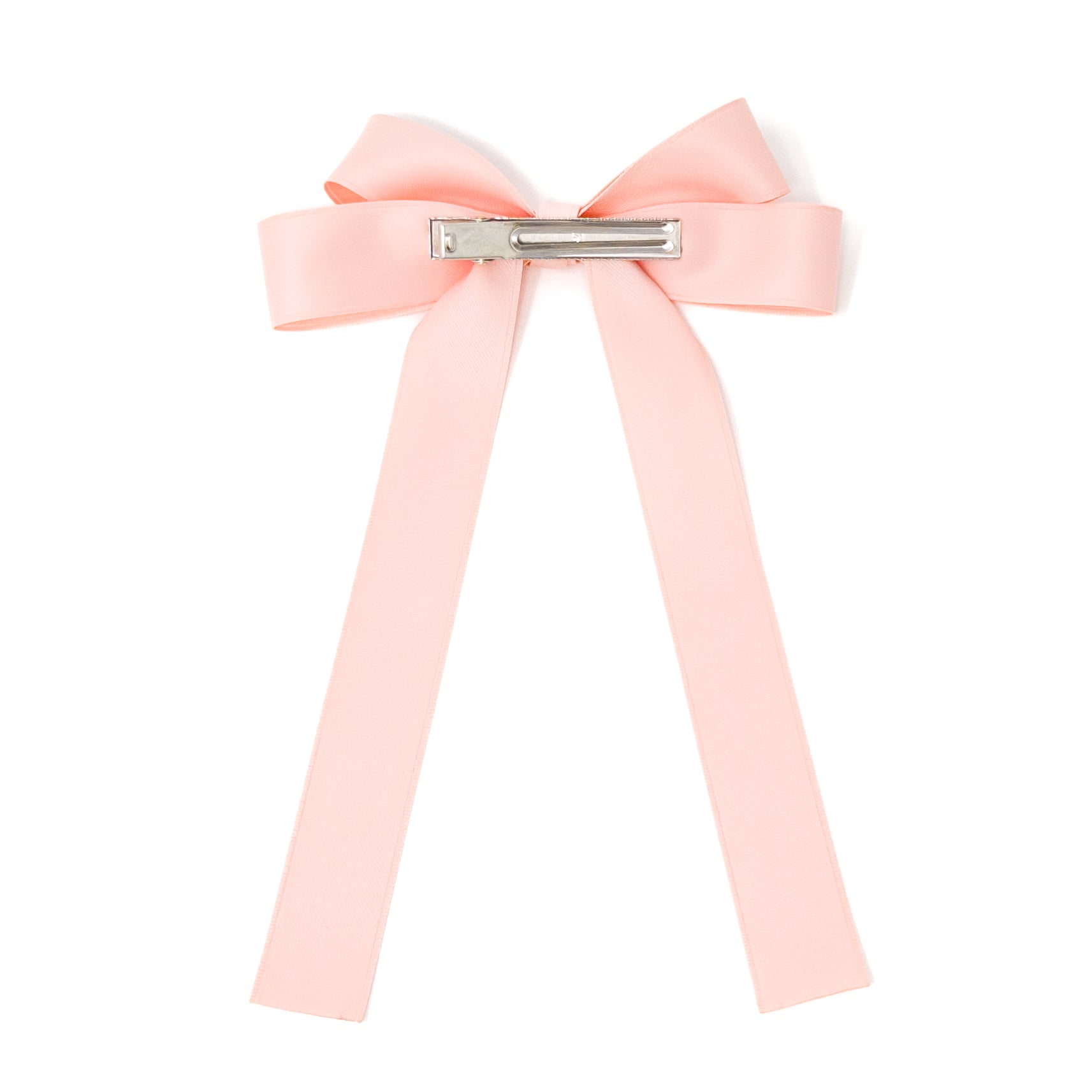 Pale pink ribbon hair bow with silver clip on white background.