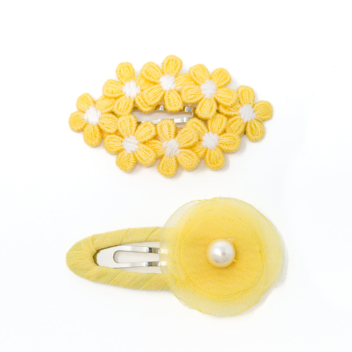 Two yellow flower hair clips.