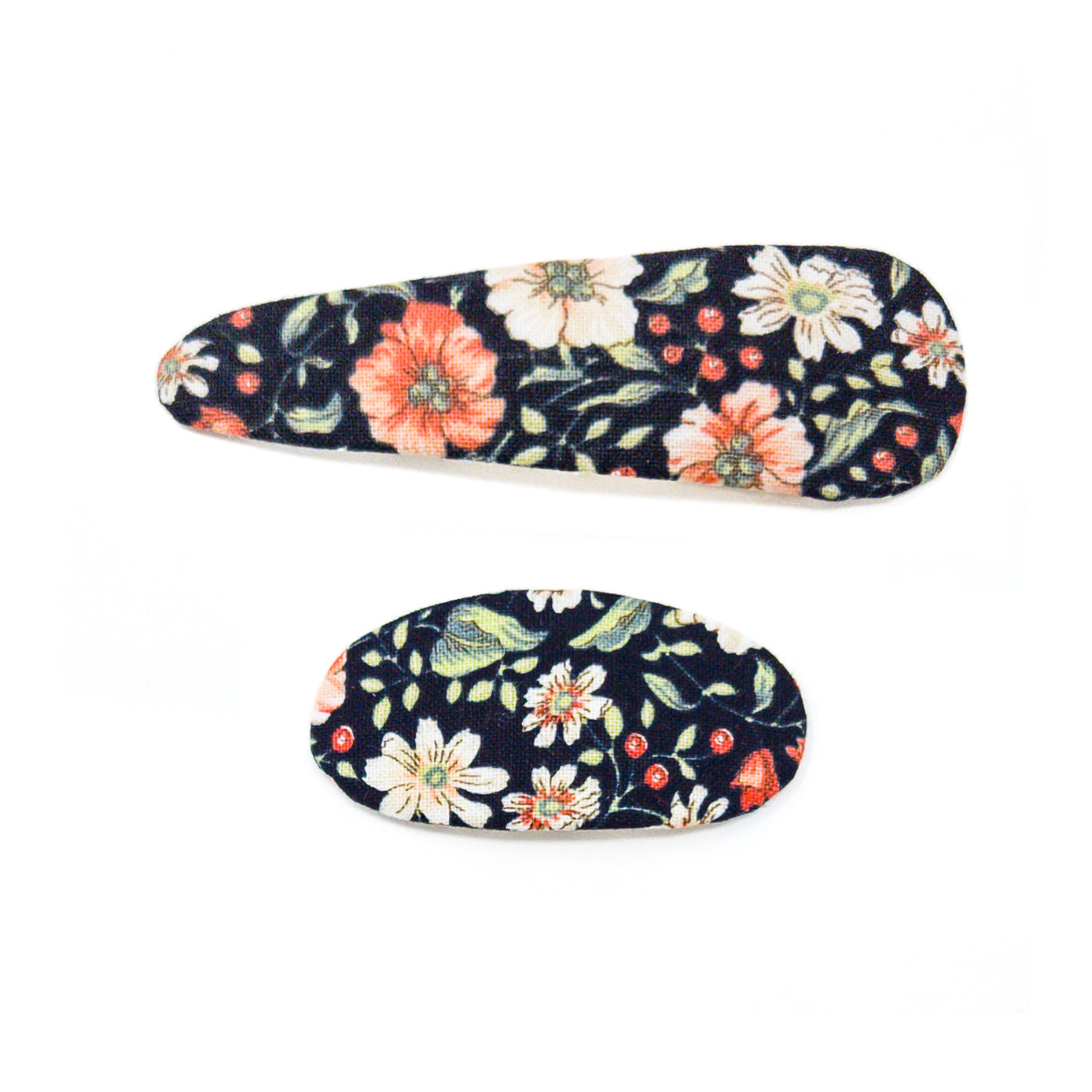 Two floral-patterned fabric hair clips on a white background.