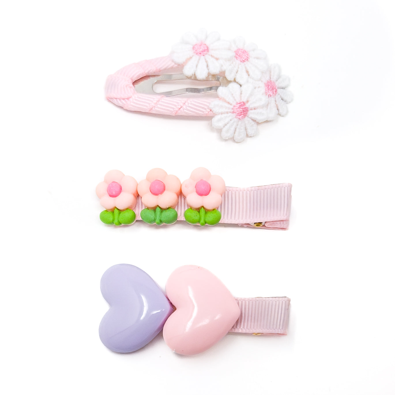 Three hair clips with pink and white accents.
