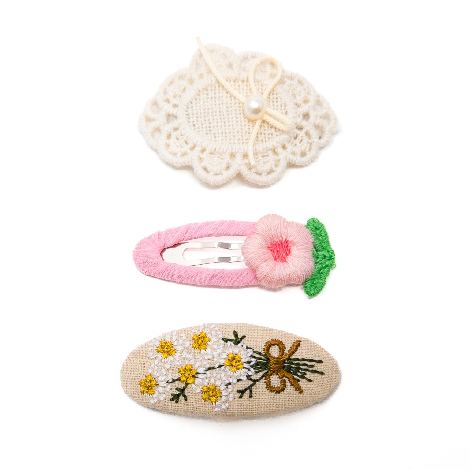 Three hair clips with floral patterns.