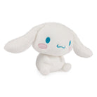 White plush Cinnamoroll doll with blue eyes and pink cheeks sitting upright.
