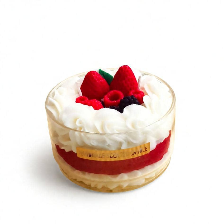 Dessert with whipped cream and berries in a glass container on a white background