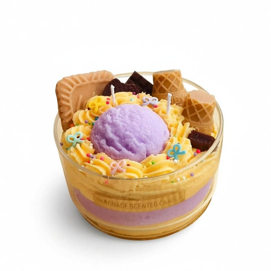 Candle designed to look like a dessert with ice cream, waffles, and sprinkles on a white background.