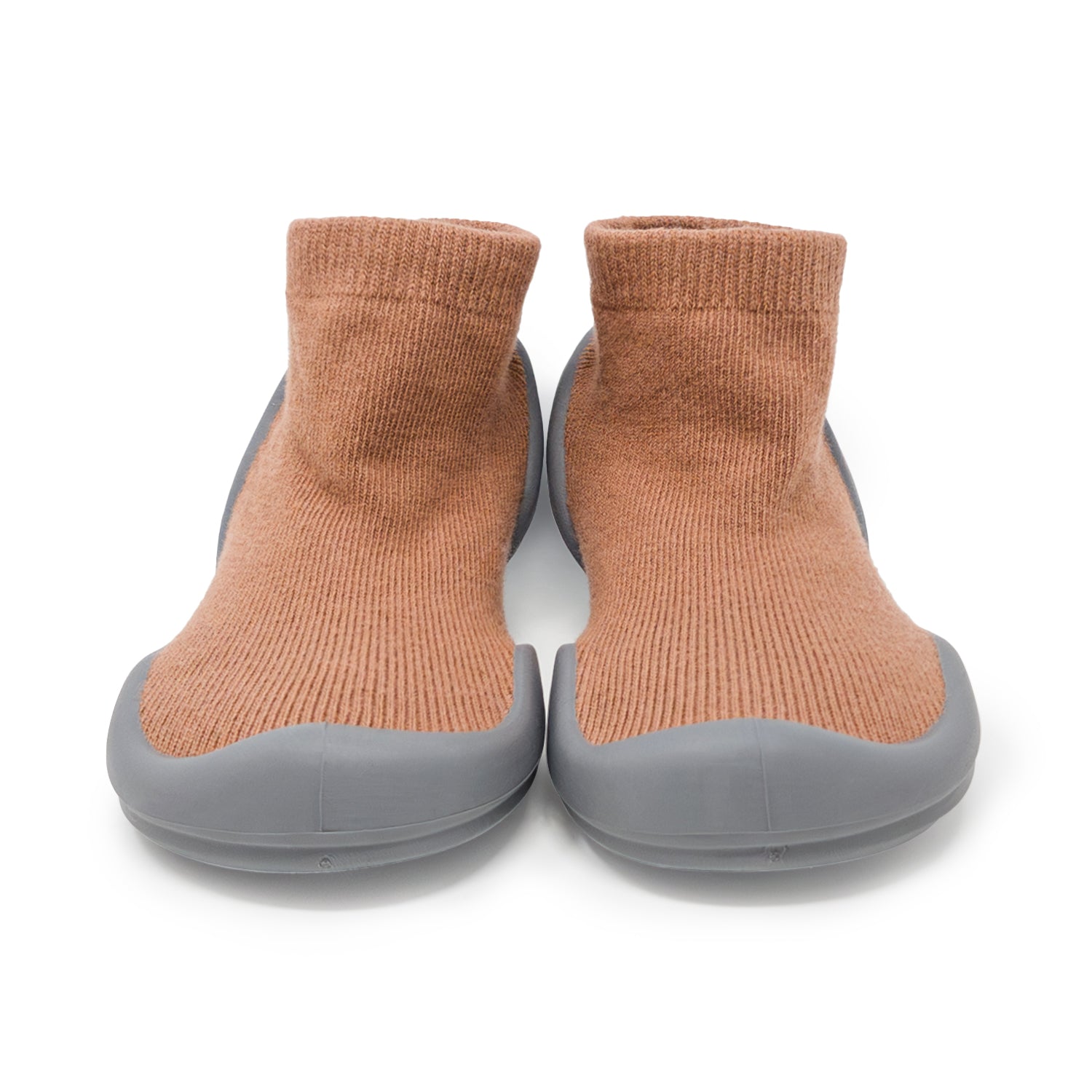 A pair of brown sock shoes with gray soles.