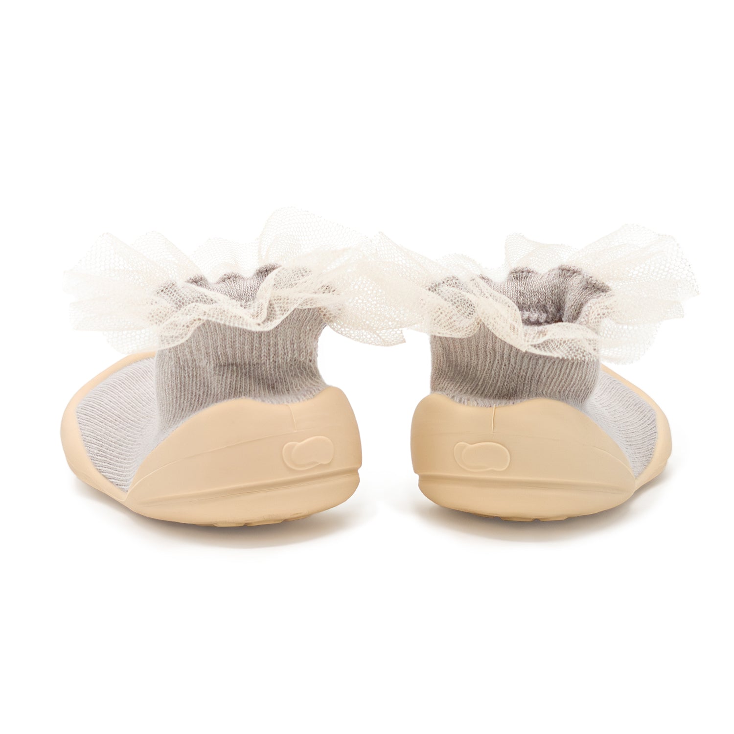 Two baby sock shoes with beige soles, gray socks, and white lace trim.