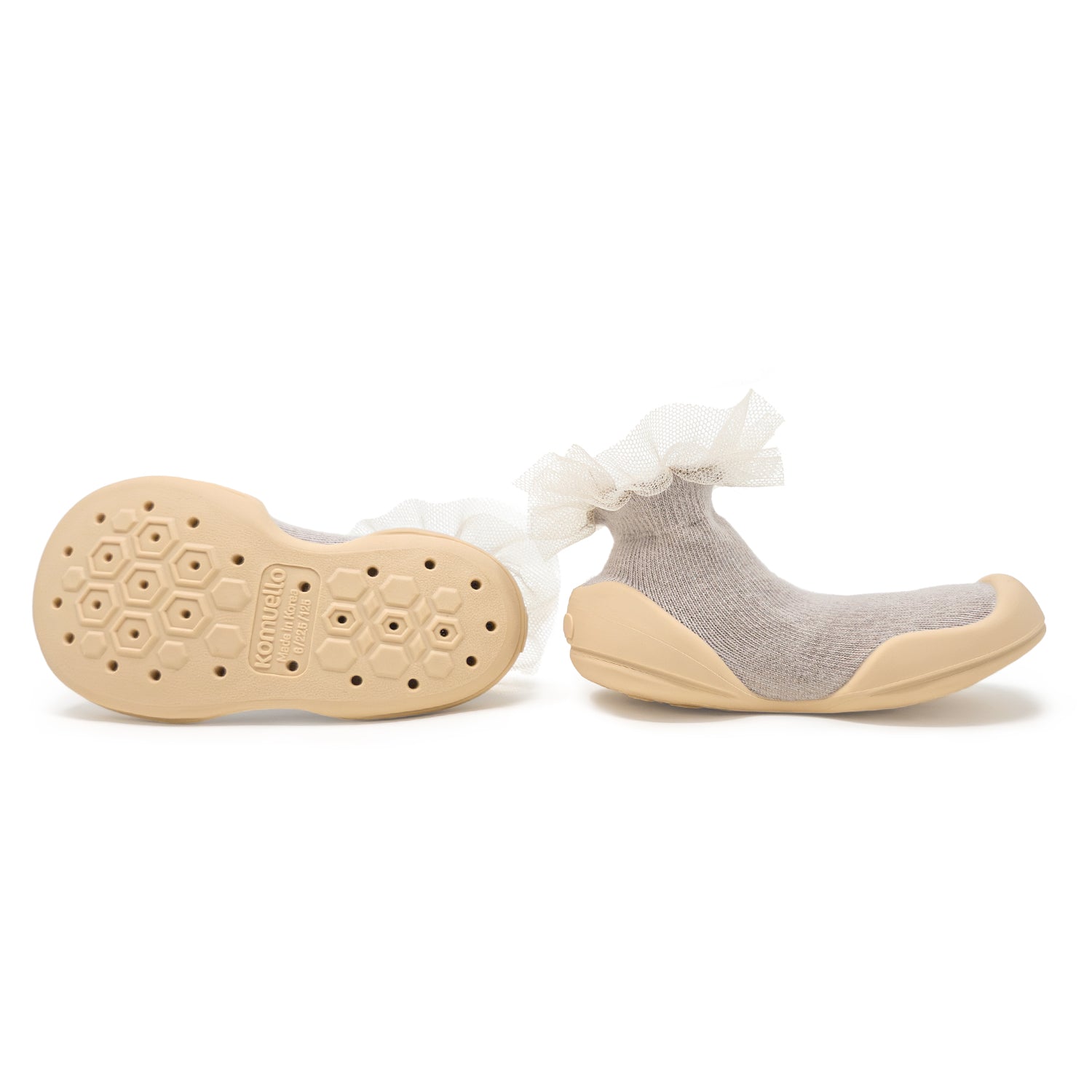 Two beige and gray toddler shoes with white lace detailing.