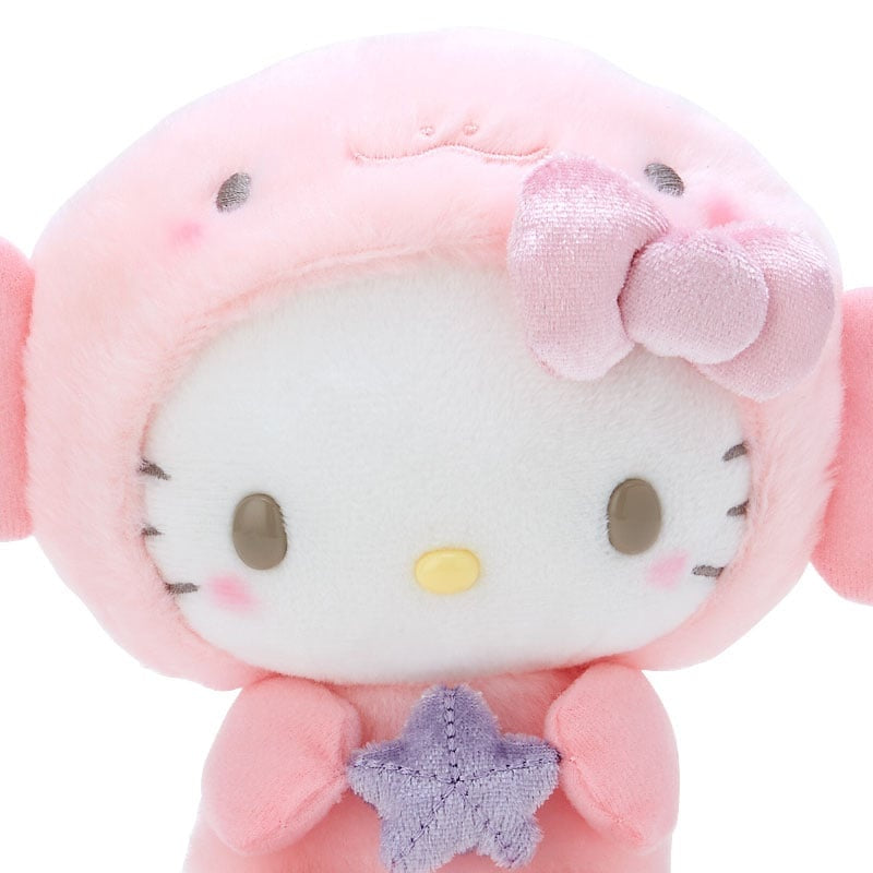 Close-up of a pink Hello Kitty plush toy wearing a pink hood with a bow and holding a purple star.