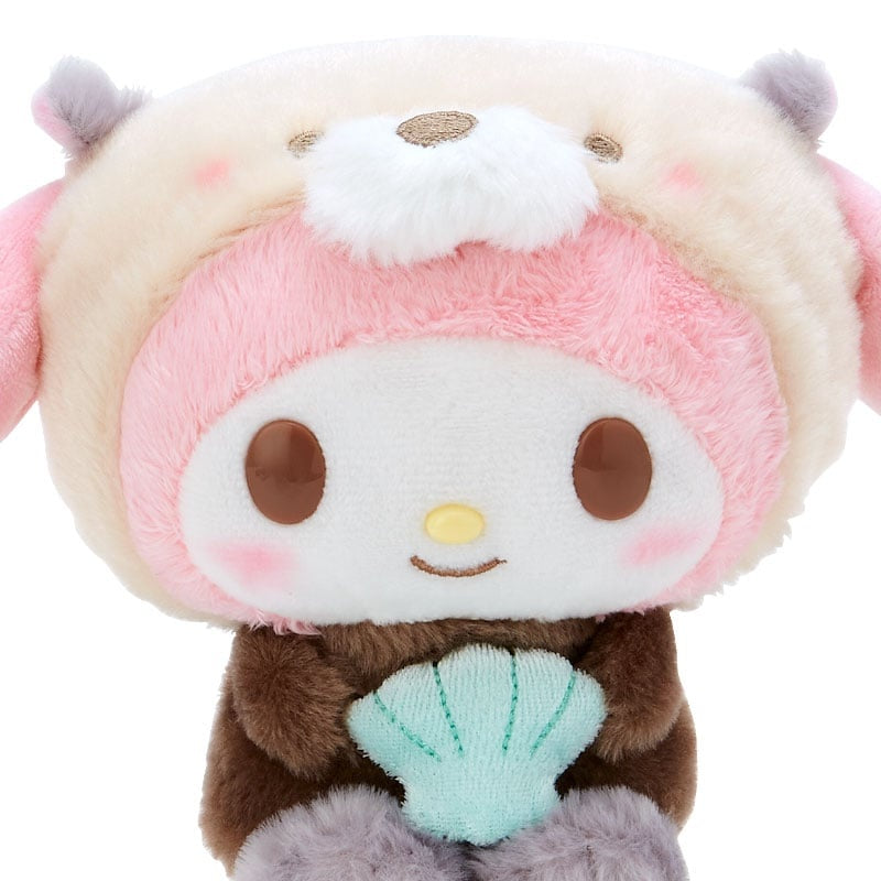 Plush toy featuring a character wearing a bear-like costume, holding a seashell.