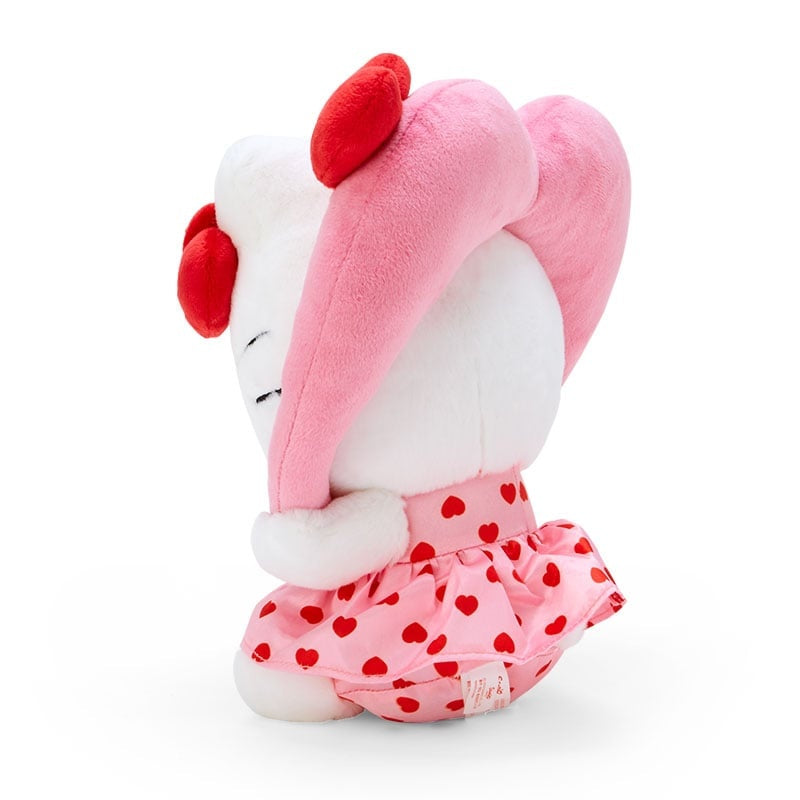 White plush toy with pink heart dress, red bows, and long pink ears.