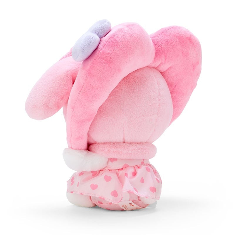 Pink plush toy with heart-print dress and light purple bow.