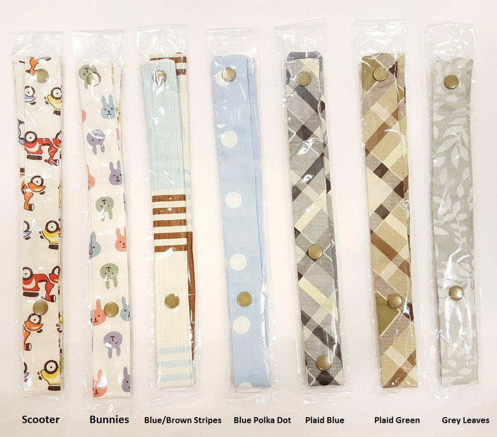 Packaged fabric strips with snaps, featuring scooter, bunny, stripe, polka dot, plaid, and leaf prints.