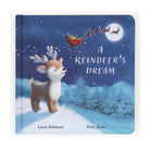 Children's book, "A Reindeer's Dream," featuring an illustration of a young reindeer looking up at Santa's sleigh flying across the moonlit sky.