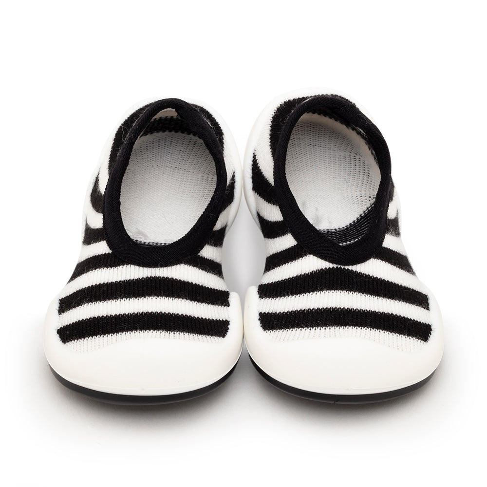 Pair of black and white striped baby shoes.