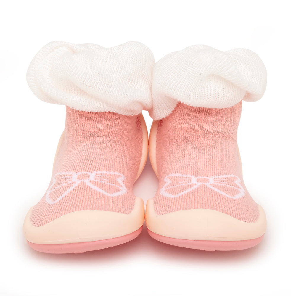 Pink sock-shoes with white trim and bow detail.