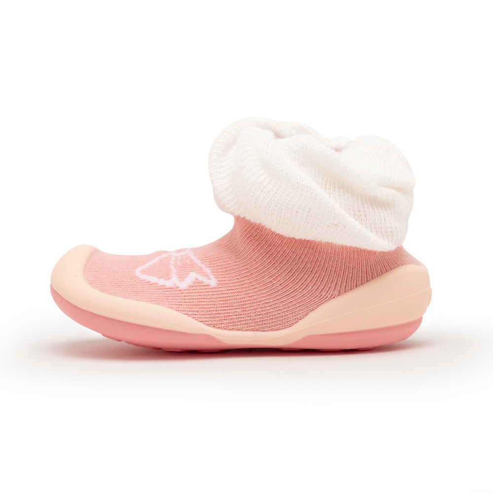 Pink baby shoe with white sock liner.