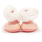 A pair of pink and white baby shoes.