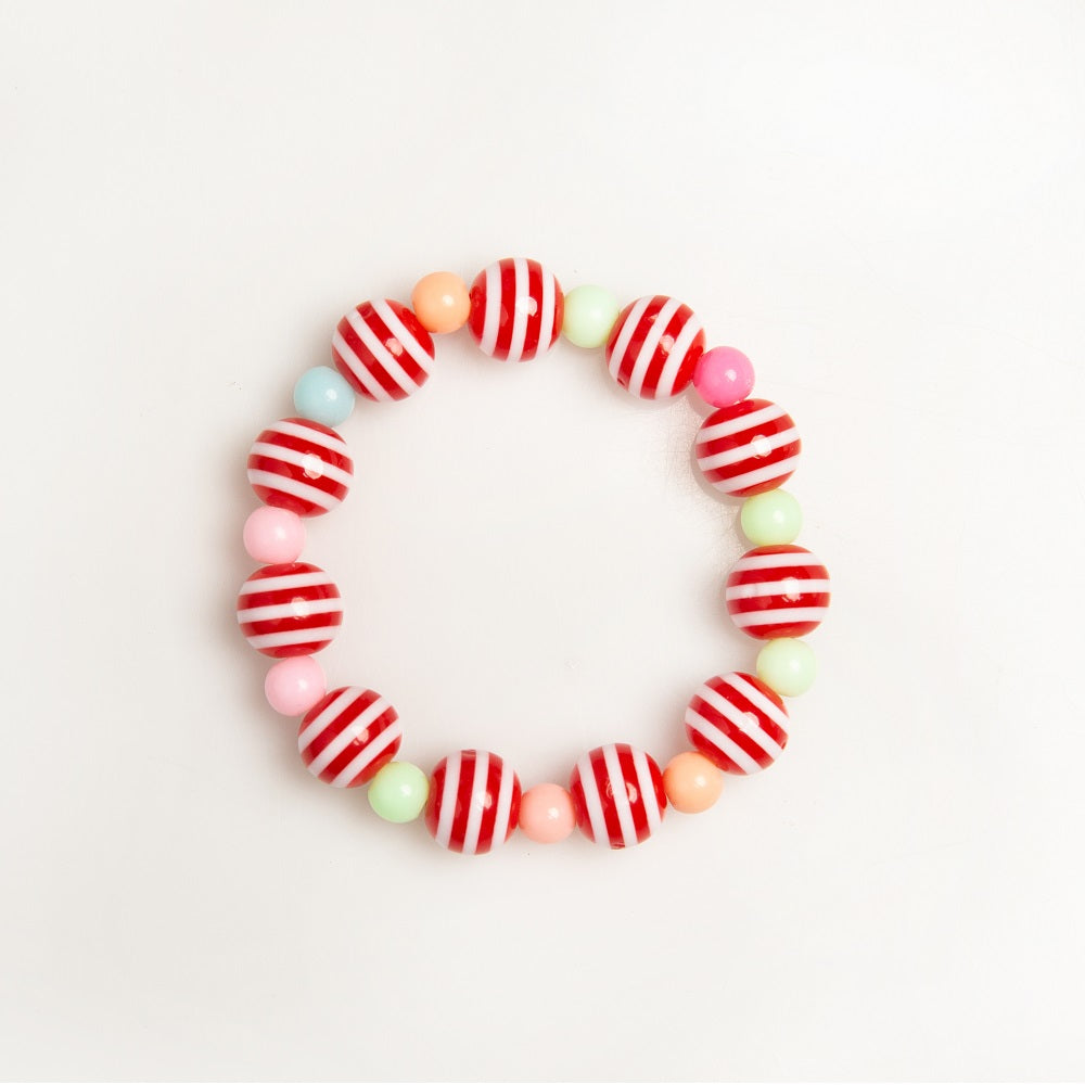 Close-up of a beaded bracelet featuring red and white striped beads, alternating with small, colorful pastel beads.