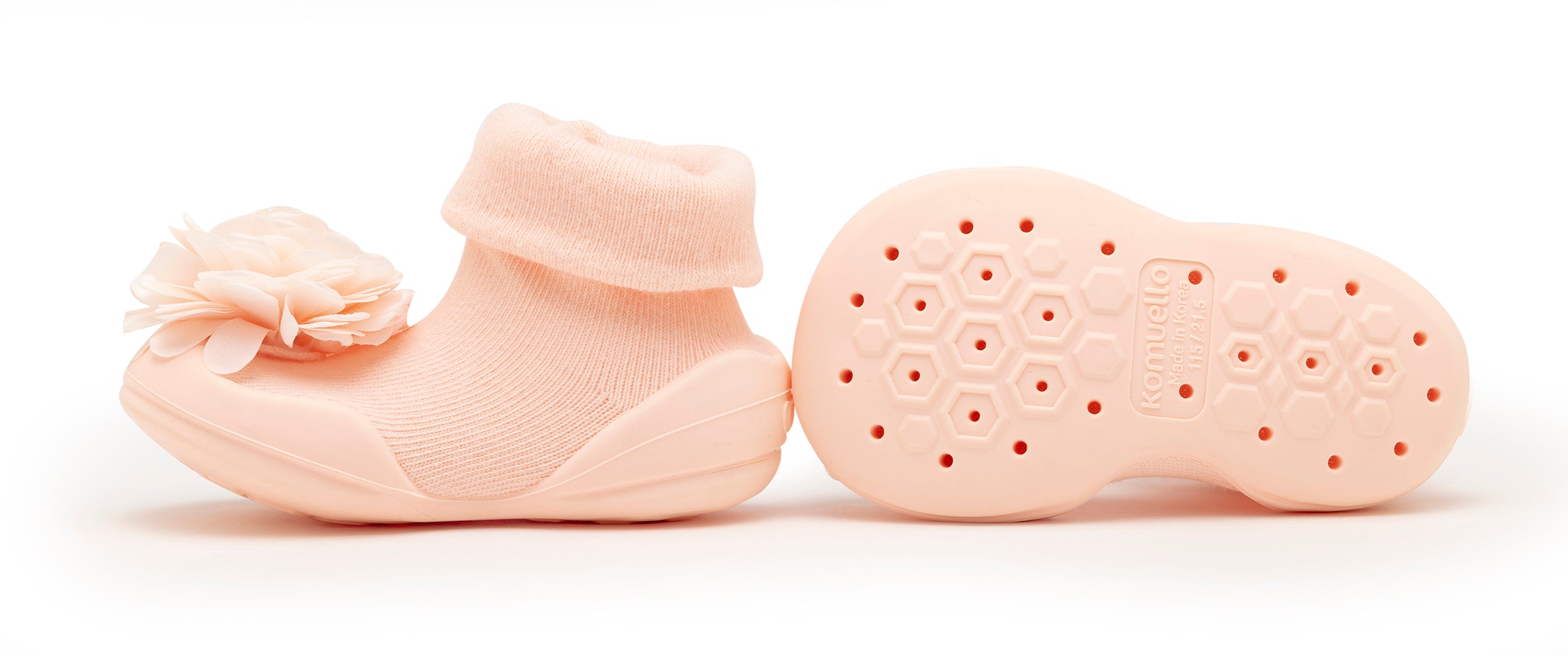 Pair of pink baby sock shoes with a flower accent.