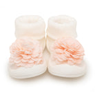 Baby socks with a pale pink flower detail.