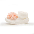Infant sock shoe, white, with peach flower.