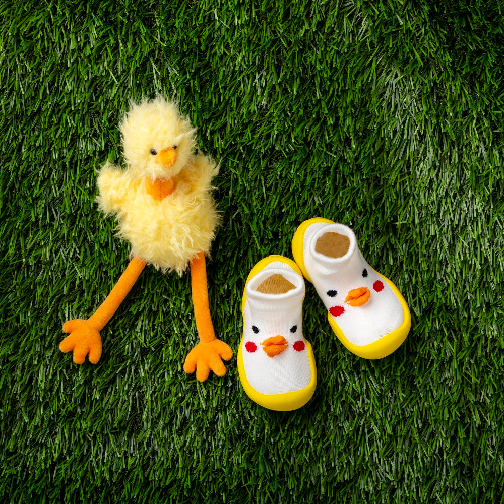 Artificial grass, plush chick, and duckling booties.