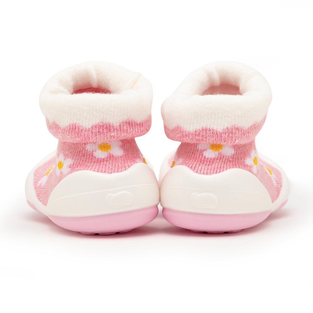 Back view of pink and white baby booties.