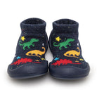 Pair of navy blue baby socks with dinosaur patterns.