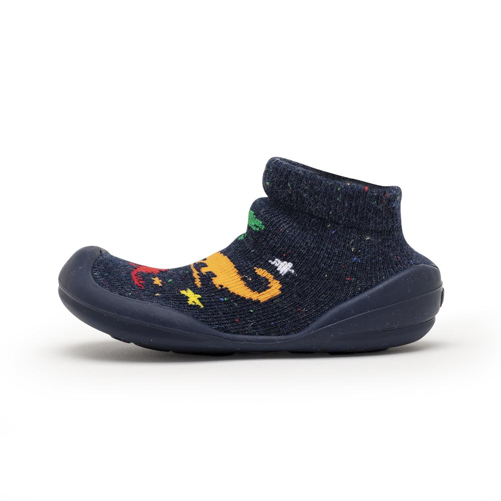 Navy blue baby shoe-sock with colorful dinosaur design.