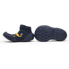 Navy blue slipper socks with dinosaur pattern and flexible sole.