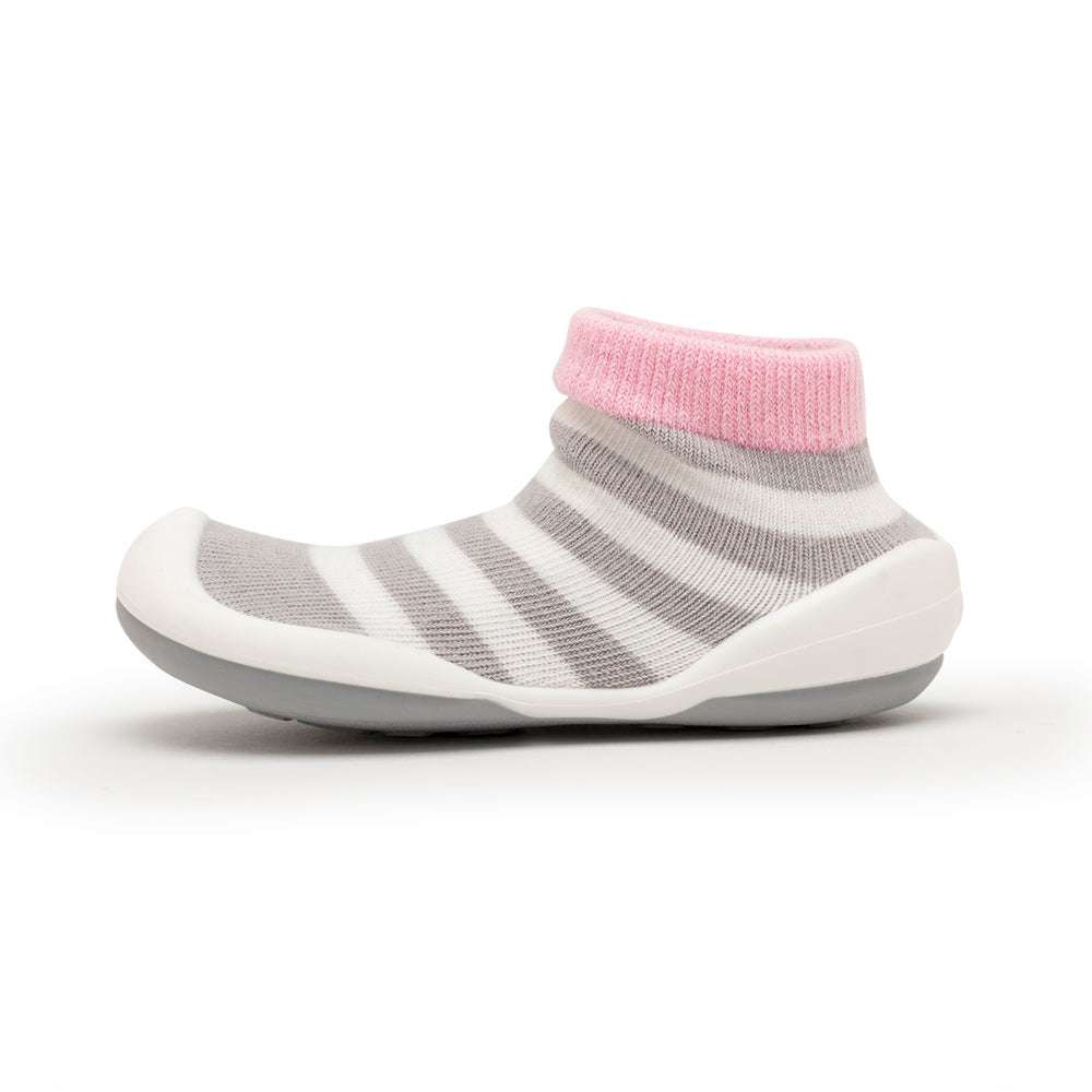 Striped baby sock shoe with pink cuff.