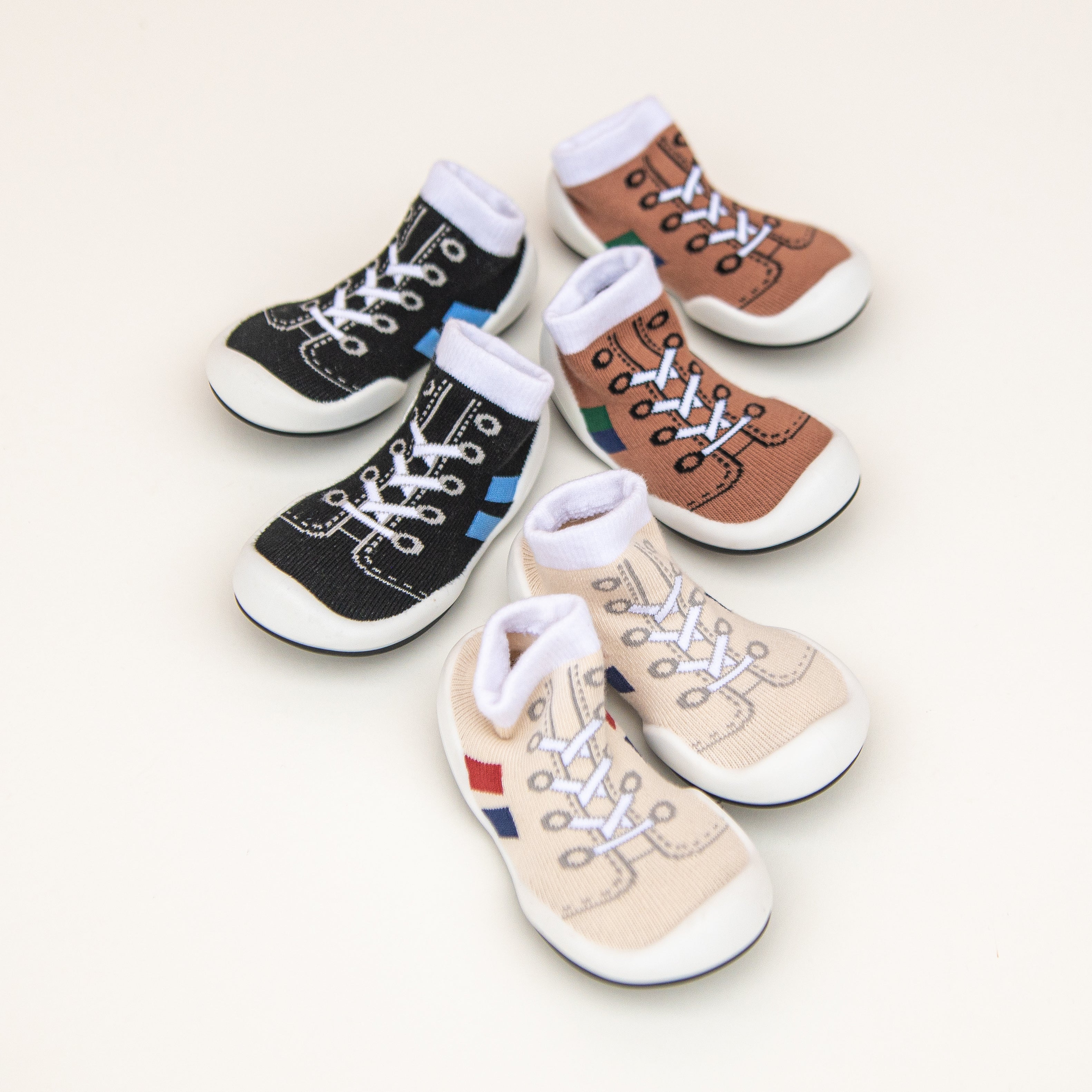 Six sock shoes resembling sneakers, in black, brown, and beige.