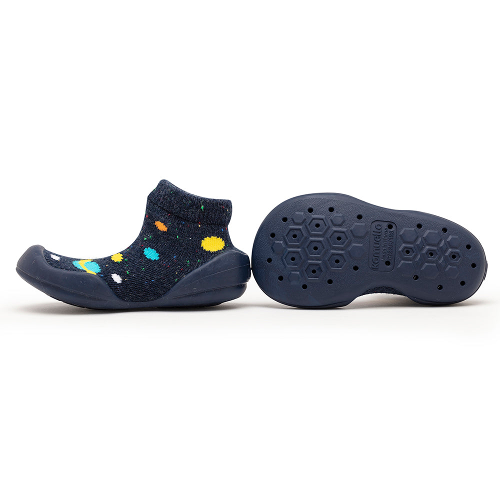 Two blue sock-shoes, one with colorful dots. One sole showing.