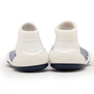 Back view of white sock shoes with navy soles.