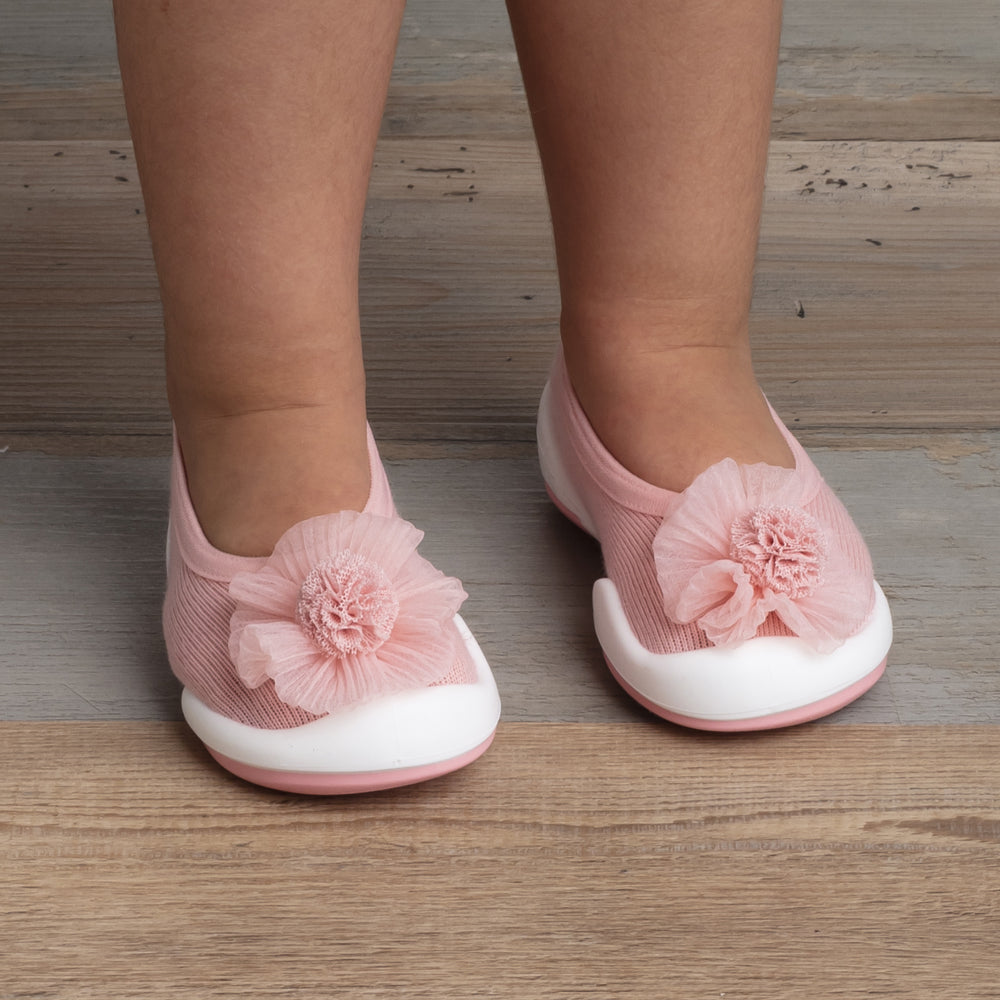 Toddler's pink shoes with flowers.