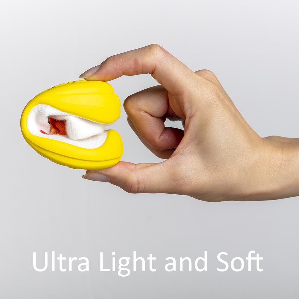 Hand holding folded yellow shoe with sock.